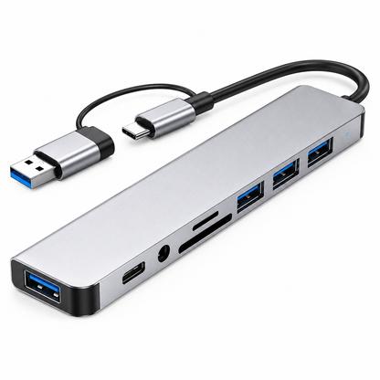 PrimeSync 8-in-1 Dual USB-C Hub shown in an isometric view against a clean white background. Features a premium silver-anodized aluminum chassis, a soft blue LED status indicator, and a hybrid USB-C to USB-A host connector cable.