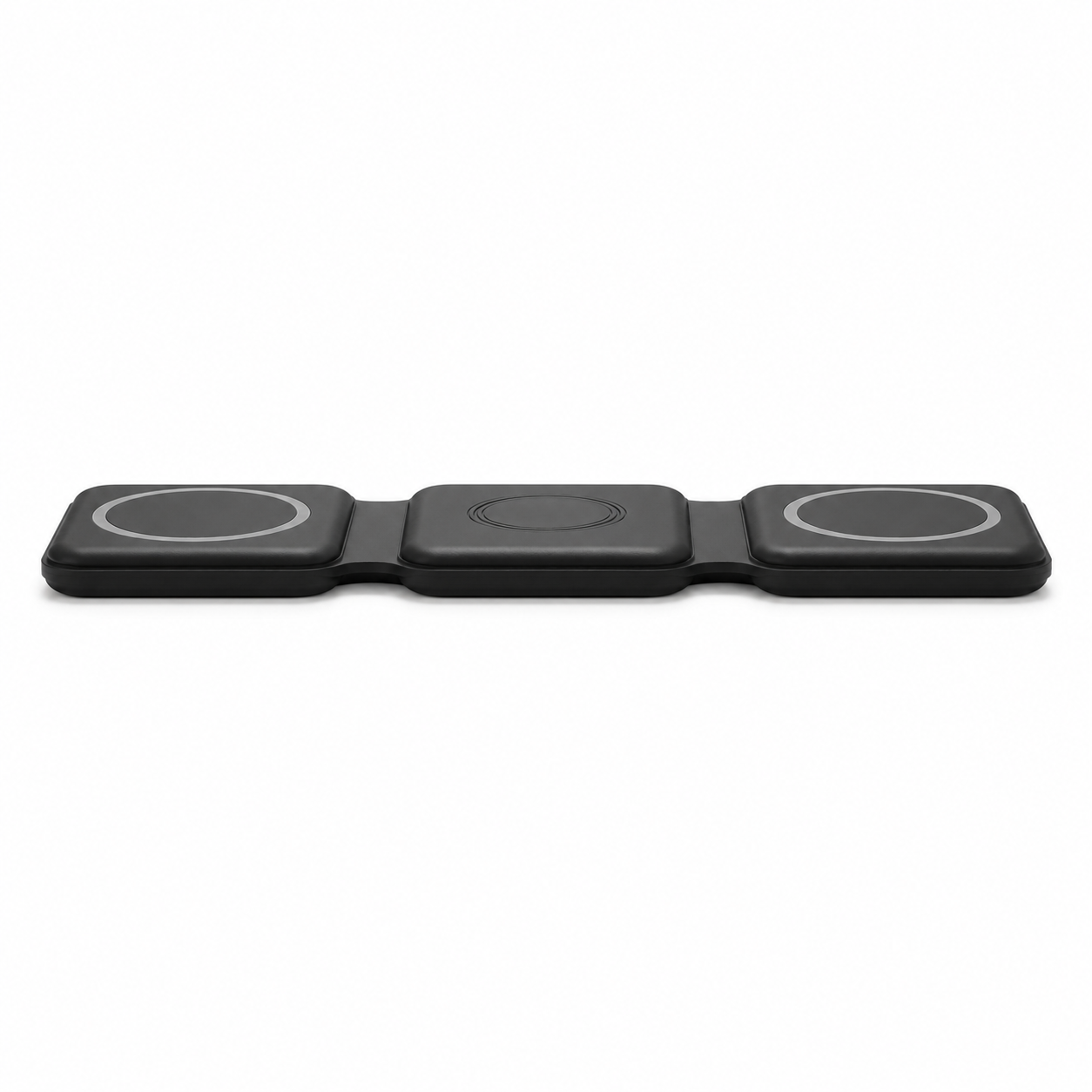 Extreme low-angle side profile view of the PrimeSync black foldable magnetic travel charger lying flat on a desk. Highlights the exceptionally slim, low-profile design and the flexible silicone hinges engineered for compact travel storage.