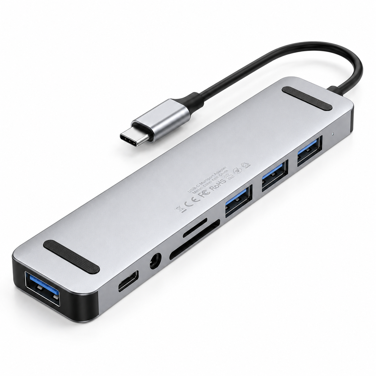 Underside view of the PrimeSync USB-C Hub, showing two non-slip black rubber grip pads on the silver aluminum bottom plate. Laser-etched text displays standard global consumer electronic regulatory compliance marks including CE, FCC, and RoHS certifications.
